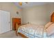 Bright bedroom with a wooden bed frame and dresser at 2542 Bobby Lee Ln, St Cloud, FL 34772