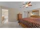 Spacious bedroom with ensuite bathroom access and a large dresser at 2542 Bobby Lee Ln, St Cloud, FL 34772