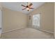 Simple bedroom with ceiling fan and window with curtains at 2542 Bobby Lee Ln, St Cloud, FL 34772