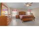 Main bedroom with large bed, dresser, and ceiling fan at 2542 Bobby Lee Ln, St Cloud, FL 34772