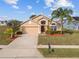House exterior with palm trees, driveway and manicured lawn at 2542 Bobby Lee Ln, St Cloud, FL 34772