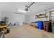 Spacious garage with ample storage shelving and space for multiple vehicles at 2542 Bobby Lee Ln, St Cloud, FL 34772