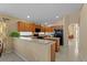 Kitchen features a large island, oak cabinets, and black appliances at 2542 Bobby Lee Ln, St Cloud, FL 34772
