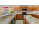 Kitchen with oak cabinets, black appliances, and a breakfast bar at 2542 Bobby Lee Ln, St Cloud, FL 34772