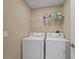 Laundry room with washer, dryer, and shelving for storage at 2542 Bobby Lee Ln, St Cloud, FL 34772