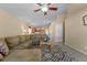Relaxing living room with L-shaped sofa and view to kitchen at 2542 Bobby Lee Ln, St Cloud, FL 34772