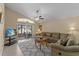 Living room with L-shaped sofa, sliding doors, and a ceiling fan at 2542 Bobby Lee Ln, St Cloud, FL 34772