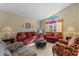 Living room with two sofas, an ottoman, and a large window at 2542 Bobby Lee Ln, St Cloud, FL 34772