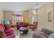 Living area with comfy seating, large window, and tiled floors at 2542 Bobby Lee Ln, St Cloud, FL 34772