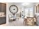 Elegant dining area with wood table, chairs, and a large clock at 2935 Rapollo Ln, Apopka, FL 32712