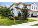 View of the home's side, showcasing landscaping and a brick walkway at 2935 Rapollo Ln, Apopka, FL 32712