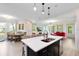 Open concept kitchen with island, white countertop and dark cabinets at 2935 Rapollo Ln, Apopka, FL 32712