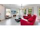 Living room with red sectional sofa, fireplace and large windows at 2935 Rapollo Ln, Apopka, FL 32712