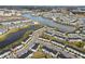 Aerial view of vibrant townhomes, community lake, and lush landscaping at 3065 Caribbean Soul Dr, Kissimmee, FL 34747
