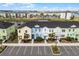 Aerial view of colorful townhouses by a lake at 3065 Caribbean Soul Dr, Kissimmee, FL 34747