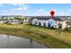 Aerial view of townhouses near a lake at 3065 Caribbean Soul Dr, Kissimmee, FL 34747
