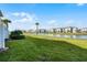 Grass backyard with lake and community view at 3065 Caribbean Soul Dr, Kissimmee, FL 34747