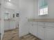 White bathroom cabinets, additional storage, and view to another bathroom at 3065 Caribbean Soul Dr, Kissimmee, FL 34747