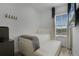 Small bedroom with twin bed, window, and built-in storage at 3065 Caribbean Soul Dr, Kissimmee, FL 34747