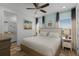 Main bedroom with king bed, ensuite bathroom, and coastal art at 3065 Caribbean Soul Dr, Kissimmee, FL 34747