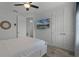 Main bedroom with queen bed, access to hallway, and large TV at 3065 Caribbean Soul Dr, Kissimmee, FL 34747