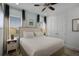 Main bedroom with king-size bed, nightstands, and large windows at 3065 Caribbean Soul Dr, Kissimmee, FL 34747