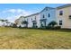 Row of colorful townhouses near a grassy area at 3065 Caribbean Soul Dr, Kissimmee, FL 34747