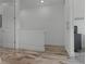 Clean hallway with wood-look tile floors and access to bedrooms at 3065 Caribbean Soul Dr, Kissimmee, FL 34747