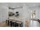 Modern kitchen with white cabinets, stainless steel appliances, and island seating at 3065 Caribbean Soul Dr, Kissimmee, FL 34747