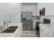 Modern kitchen with stainless steel appliances and white shaker cabinets at 3065 Caribbean Soul Dr, Kissimmee, FL 34747