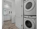 Stackable washer and dryer in a well-lit laundry closet at 3065 Caribbean Soul Dr, Kissimmee, FL 34747