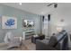 Living room with a grey couch, blue walls, and a large TV at 3065 Caribbean Soul Dr, Kissimmee, FL 34747