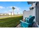 Relaxing patio with teal chairs and lake view at 3065 Caribbean Soul Dr, Kissimmee, FL 34747