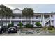 Purple two-story building with balconies, parking, and landscaping at 3133 Sun Lake Ct # B, Kissimmee, FL 34747