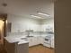 Bright eat-in kitchen with white cabinets and tile floor at 3133 Sun Lake Ct # B, Kissimmee, FL 34747