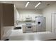 Efficient kitchen with white cabinetry, appliances, and a breakfast bar at 3133 Sun Lake Ct # B, Kissimmee, FL 34747