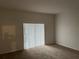 Spacious living room with carpeting and sliding glass doors at 3133 Sun Lake Ct # B, Kissimmee, FL 34747