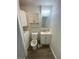 Bathroom with a toilet, sink and mirror, awaiting new owner at 342 E Tillman Ave, Lake Wales, FL 33853