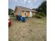 Orange house with a side yard, and recycling bins at 342 E Tillman Ave, Lake Wales, FL 33853