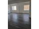 Bright living room featuring windows, blinds, and wood-look flooring at 342 E Tillman Ave, Lake Wales, FL 33853