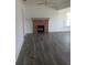 Living room showcasing a decorative fireplace and wood-look flooring at 342 E Tillman Ave, Lake Wales, FL 33853