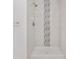 Shower with white subway tile and decorative accent tile at 4181 Sw 111Th Pl, Ocala, FL 34476