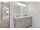 Modern bathroom vanity with double sinks, marble countertop, and gray cabinetry at 4181 Sw 111Th Pl, Ocala, FL 34476