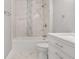Bathroom featuring a marble tiled shower and a modern white vanity, with tile floors at 4181 Sw 111Th Pl, Ocala, FL 34476