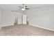 Bedroom featuring neutral walls and carpeted flooring, with a ceiling fan and a view into other rooms at 4181 Sw 111Th Pl, Ocala, FL 34476
