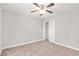 Clean bedroom with neutral carpet, a ceiling fan, and a closet, offering a cozy and versatile space at 4181 Sw 111Th Pl, Ocala, FL 34476
