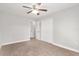 Bedroom with a ceiling fan, carpet flooring, and closet space at 4181 Sw 111Th Pl, Ocala, FL 34476