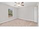 Another bright bedroom with neutral walls, carpet flooring, and a window at 4181 Sw 111Th Pl, Ocala, FL 34476