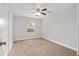 Bedroom with a ceiling fan, neutral walls, carpet flooring, and a single window providing natural light at 4181 Sw 111Th Pl, Ocala, FL 34476