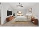 Comfortable bedroom featuring a ceiling fan, carpeted flooring, and a window providing natural light at 4181 Sw 111Th Pl, Ocala, FL 34476